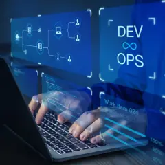Ręce programisty pracującego na laptopie, wizualizacja zastosowania chmury obliczeniowej i DevOps.